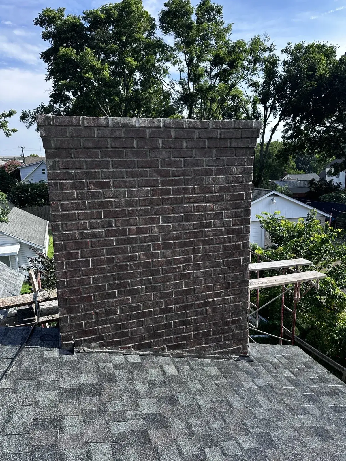 Wide view of a rebuilt brick chimney