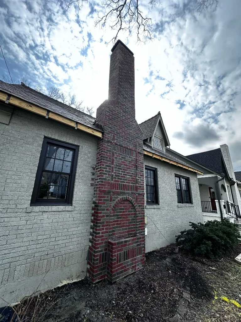 Decorative red and charcoal brick chimney after rebuild