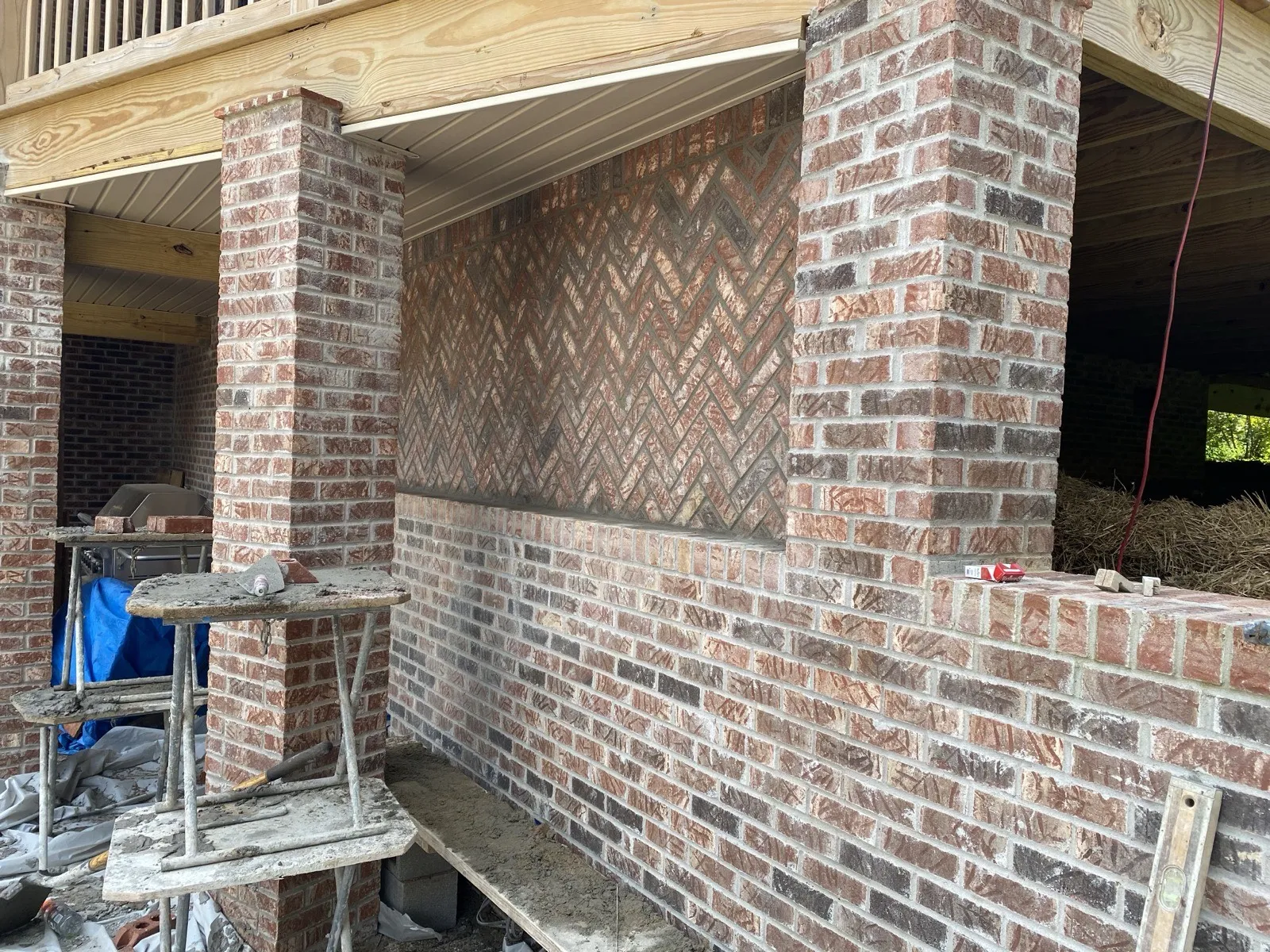 Finished exterior brick wall with chevron pattern