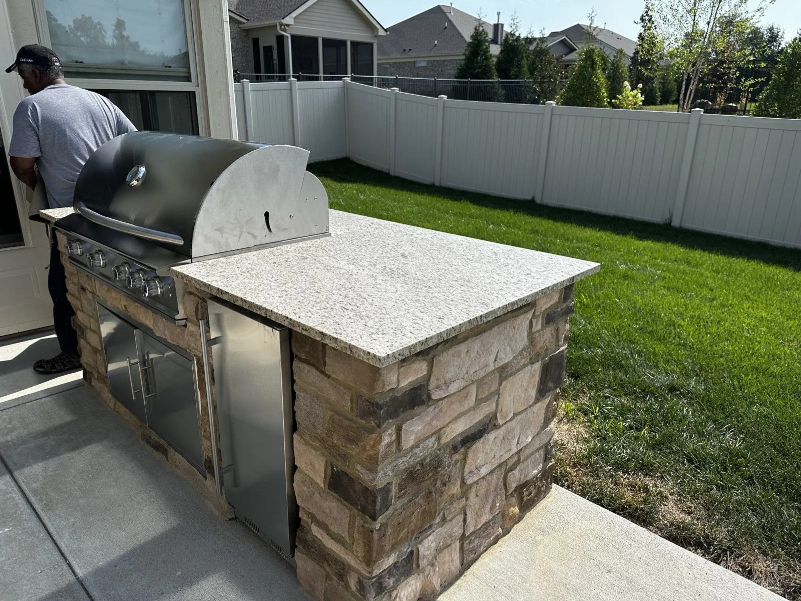 Stone outdoor kitchen with granite countertop