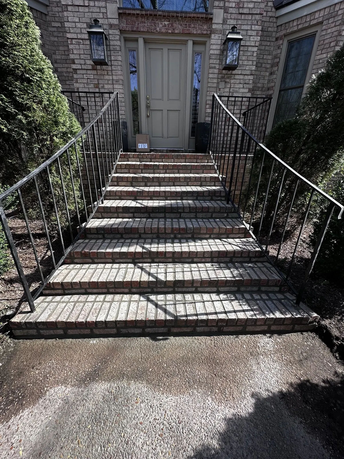 Front brick stairs after tuckpointing and repair